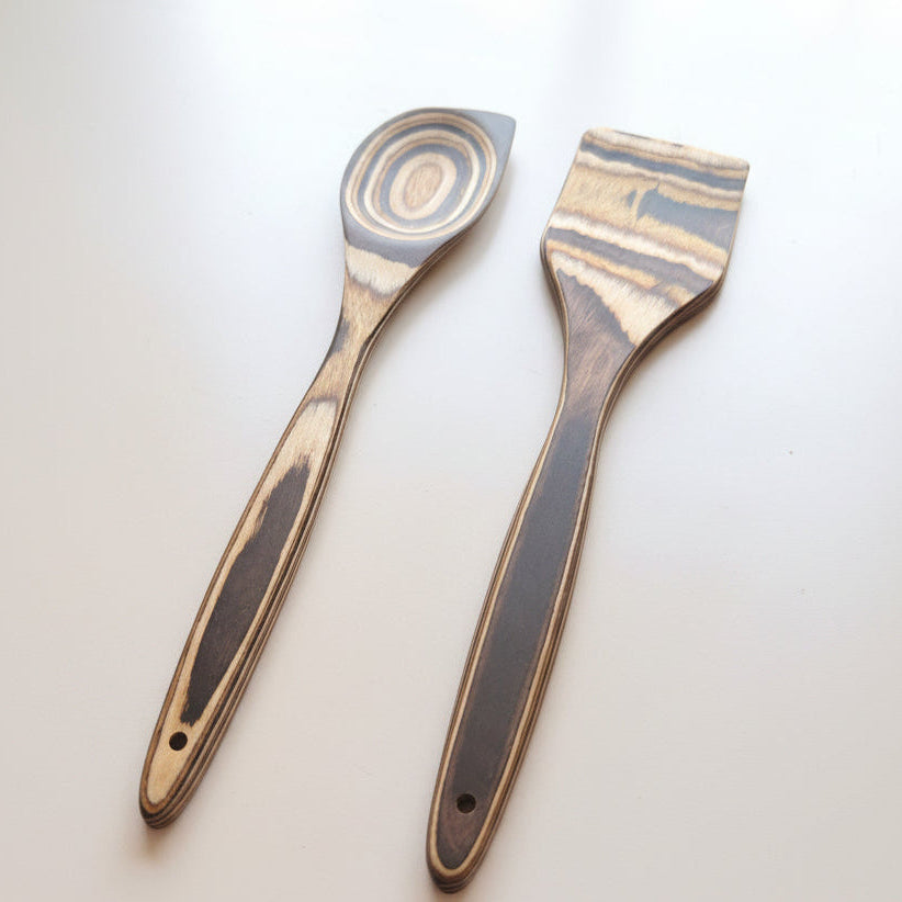Two spatulas with wooden handles on a white background