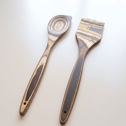 Two spatulas with wooden handles on a white background