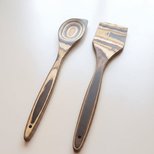 Two spatulas with wooden handles on a white background